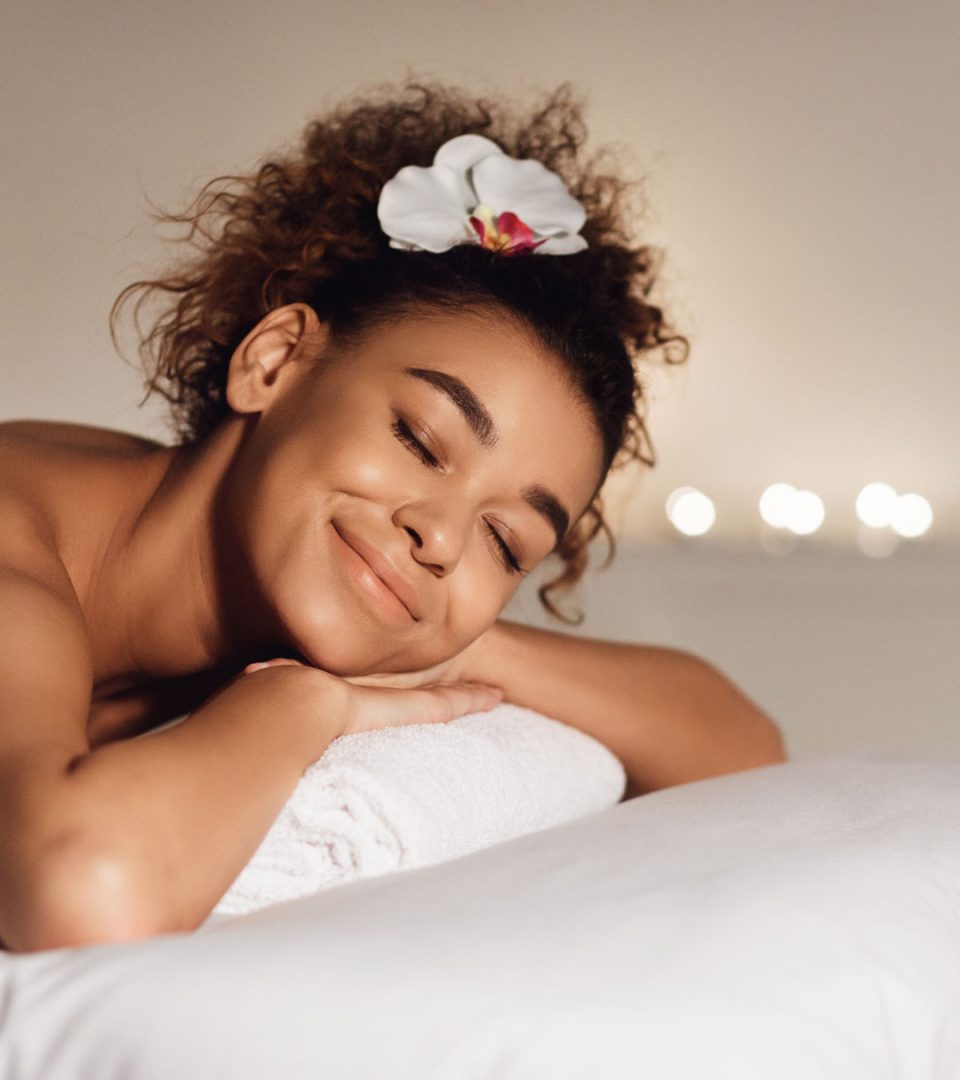 massage-african-american-girl-relaxing-in-spa-FPA9EM2.jpg